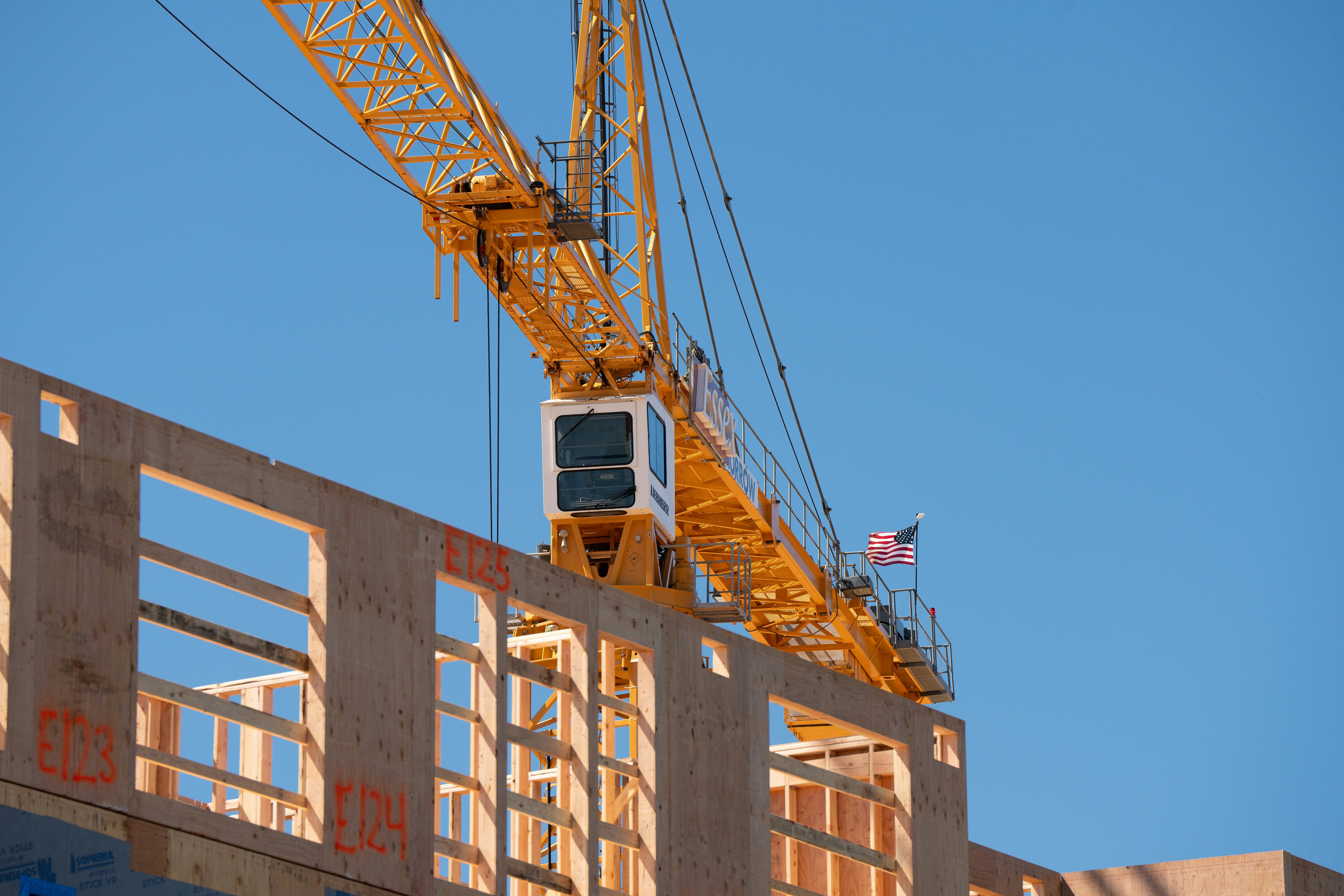 Crane on wood-frame construction site